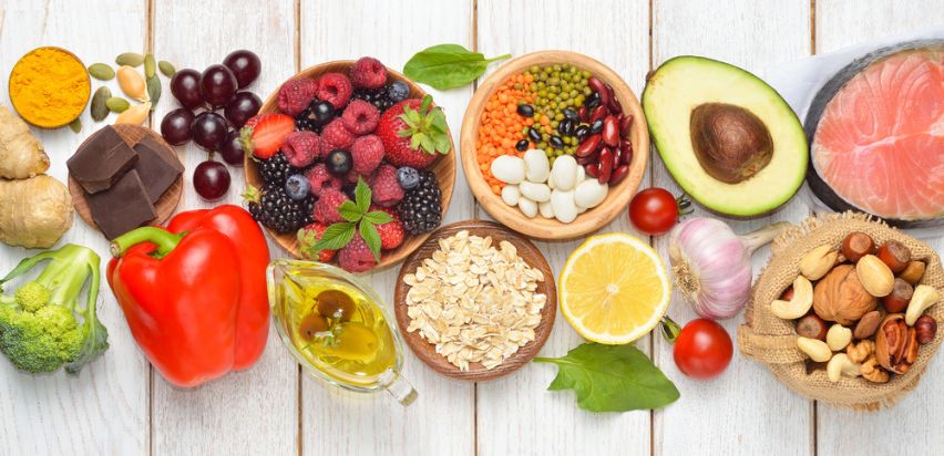 A selection of vegetables, meats, fruits, nuts, and pulses. 