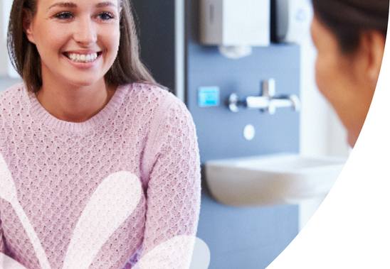 Patient smiling to the doctor in clinic
