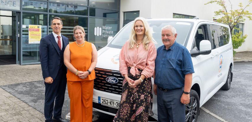 Dr. Mazen El Bassiouni, Dr. Lorraine Walshe, Lisa Cummins, and Sean Lyons standing beside the Kerry Cancer Bus in front of the Mid-Western Radiation Oncology Centre in Limerick.