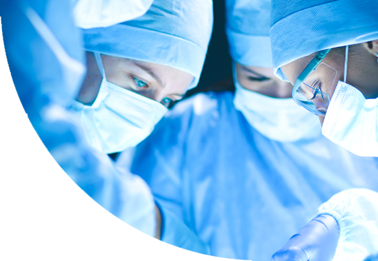 Team of surgeons wearing scrubs and masks in an operating theatre